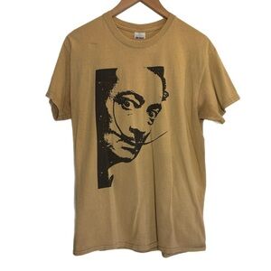 Tan short sleeve shirt w/ Salvador Dali face on front